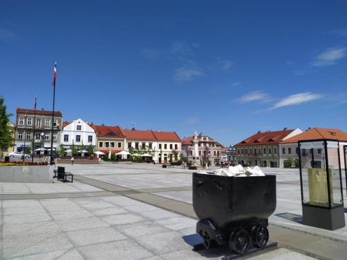a trash can sitting in the middle of a parking lot at Dom pod Galazka in Bochnia