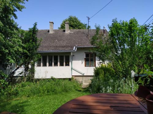 an old white house with a pathway in front of it at Dom pod Galazka in Bochnia