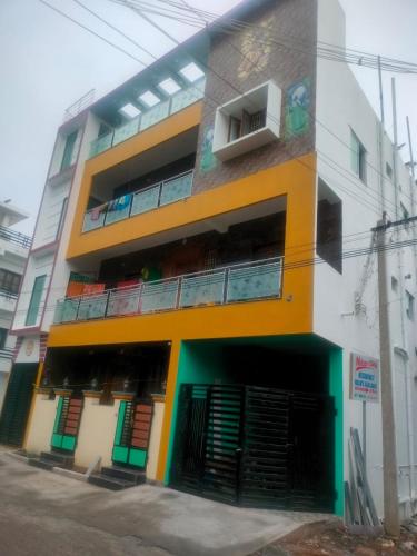 a multicolored building with a balcony on a street at Marine Beach Villa in Puducherry