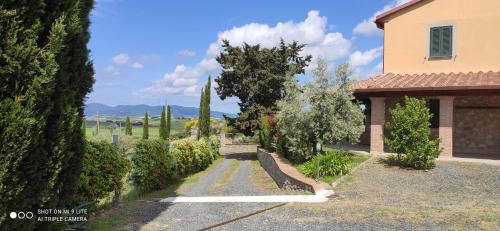a house with a garden with trees and a road at Cintoia, Tuscany Beautiful villa with private pool in Santa Luce