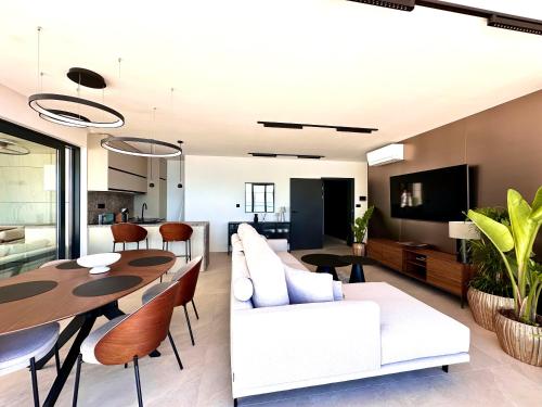 a living room with a white couch and a table at Hotel Medistone in Omiš