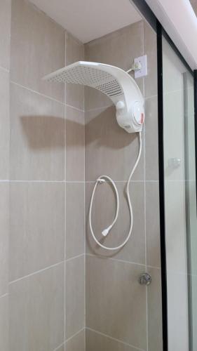a shower with a shower head in a bathroom at POUSADA MIRANTE DO VALE in Serra de São Bento