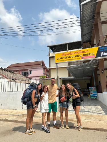 a group of people standing in front of a building at Vang Vieng Global Hostel in Vang Vieng