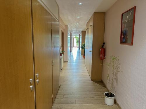 a hallway with wood floors and a long corridor at Hotel DenRiKo in Heidelberg