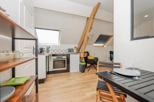 une cuisine avec une table et un comptoir dans l'établissement Ma parenthèse, à Wimereux