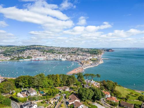 an aerial view of a beach and the ocean at The Curlews - Waterside, boutique home with 10 person spa in Bishopsteignton