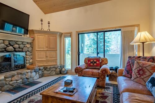 a living room with a couch and a fireplace at Greyhawk Condo 07 in Ketchum