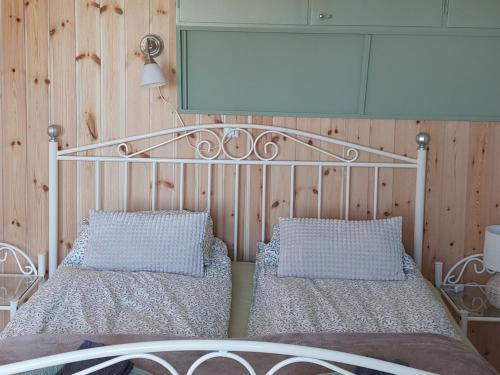 a bedroom with a metal bed and two pillows at House with lake view swedish lapland in Rusksele
