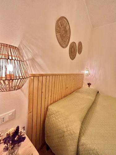 a bedroom with a bed and plates on the wall at Vicolo 35 Apartments in Trapani