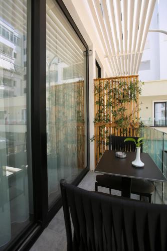 a dining room with a table and chairs at Charm Hotel in Vlorë