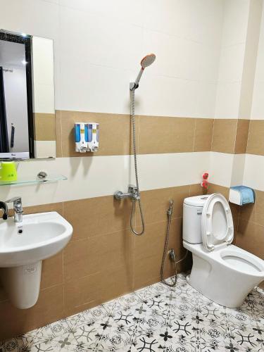 a bathroom with a shower and a toilet and a sink at Đình Vũ 3 MOTEL in Hai Phong