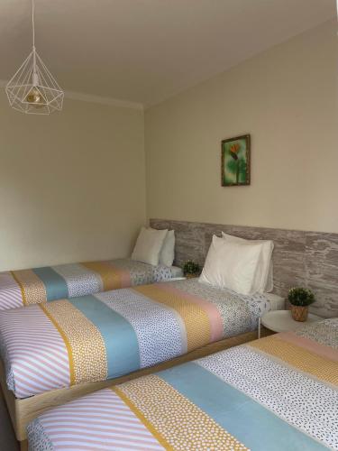 a room with three beds sitting next to each other at Quinta das Palmeiras - Casa no Campo com Piscina in Pegões