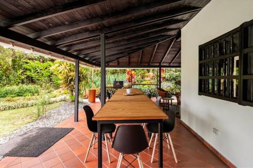 an outdoor patio with a wooden table and chairs at Villa Linderhof in Montenegro