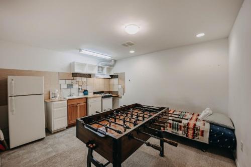a kitchen with a table in the middle of a room at 77MBR - Wi-Fi - Fireplace - Pets Ok - BBQ cabin in Glacier