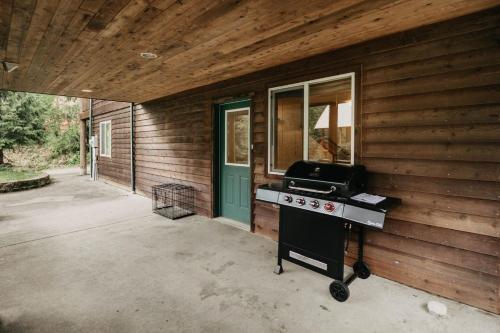 a grill on the side of a house at 77MBR - Wi-Fi - Fireplace - Pets Ok - BBQ cabin in Glacier