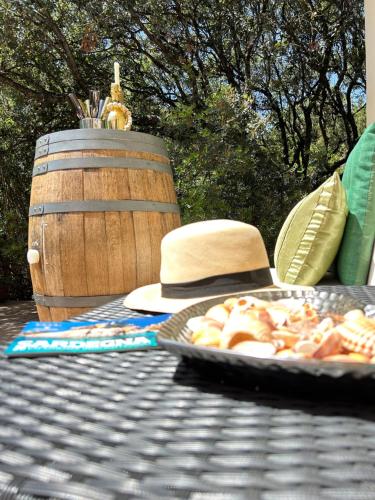 a hat and a plate of food on a table at Sardinian Seaside Retreats in Badesi