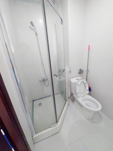 a bathroom with a shower and a toilet at Long Home 3 in Ho Chi Minh City