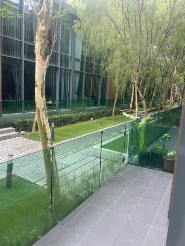 a fence with a tree in the middle of a building at Luxury, Affordable and Spacious Private Villa with Swimming Pool & Jacuzzi for 20 plus ppl Cyberjaya in Cyberjaya