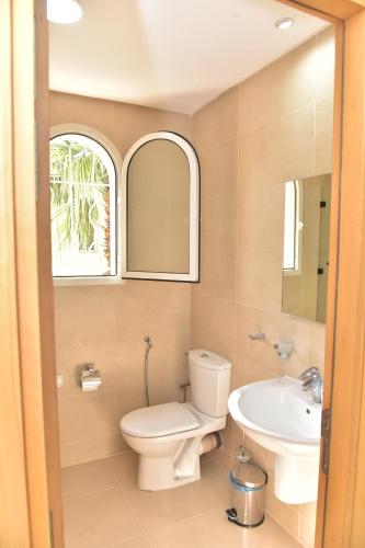 a bathroom with a toilet and a sink at Golf Royal appartement in Fès