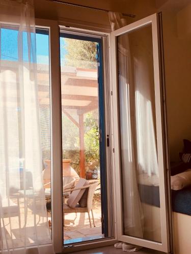 a sliding glass door with a view of a patio at Quiet Guest house in Moúdhros