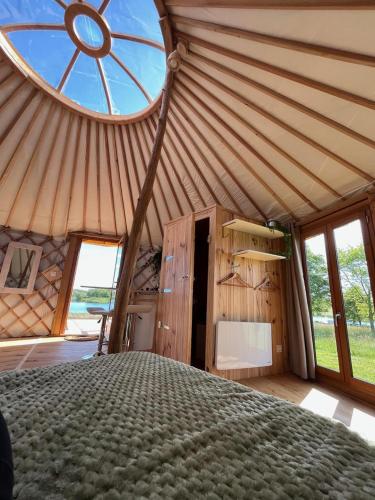 Cette grande chambre comprend un lit dans une yourte. dans l'établissement Les logements insolites de la Base Nautique, à Verneuil