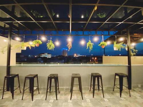 a row of stools at a bar with a view at Đình Vũ 3 MOTEL in Hai Phong