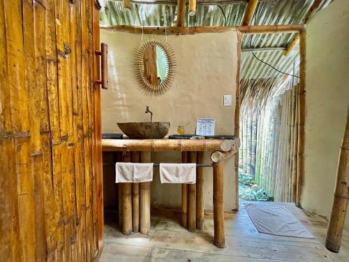 a bathroom with a wooden sink and a mirror at YAY Sustainable in Guachaca