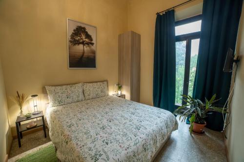 a bedroom with a bed and a large window at Locanda del Passero in Florence