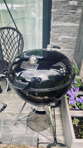 a bbq grill sitting on a patio at Apartmán Lipenka in Černá v Pošumaví