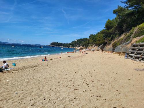 a group of people on a beach near the water at Studio à 400 m de la plage in Le Pradet