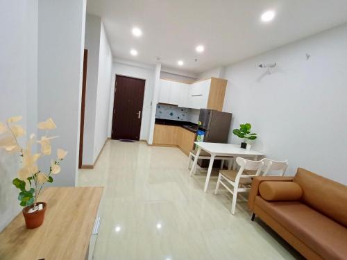a living room with a couch and a table at Lucy Cozy Apartment in Dĩ An