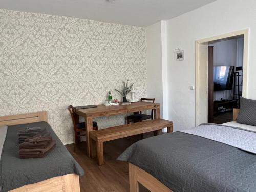 a bedroom with a desk and a bed and a table at Ferienwohnung Nauen Familie Renner in Nauen