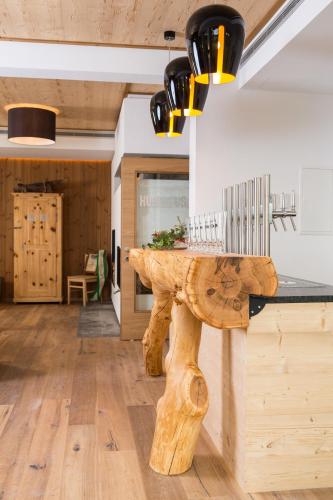 a wooden table in the middle of a room at Gasthof Hubertus in Saalfelden am Steinernen Meer