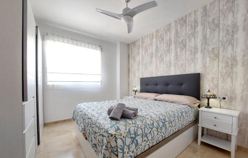 a bedroom with a bed and a ceiling fan at 2 Bedroom Gorgeous Apartment In Moncofa in Moncófar
