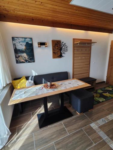 a wooden table in a room with a couch at Apartmenthaus Bader in Leutasch