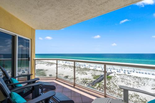 a balcony with chairs and a view of the beach at Emerald Isle Unit 607 in Pensacola Beach