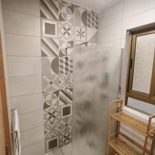 a shower with a glass door in a bathroom at SeaView Apartment in Taʼ Ġokondu