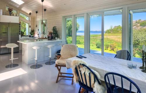 a kitchen with a table and a view of the ocean at 3 Bedroom Gorgeous Home In Tjörn in Knöde
