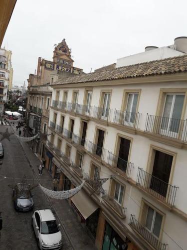 a white car parked in front of a building at Apartamento en pleno centro de Jerez de la Frontera in Jerez de la Frontera