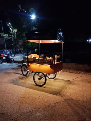 a food cart on the side of a street at night at Chalet 3 bedrooms 2 toilets lotus north cost stand alone 3 Ac 2 stand fan families are preferred in El Alamein
