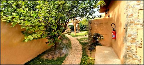 an alley with a fire hydrant next to a building at Hôtel La Belle Etoile & SPA in Saly Portudal
