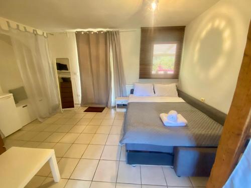 a bedroom with two beds with a heart on the bed at Kali Zoi -B&B Zakynthos in Amoudi