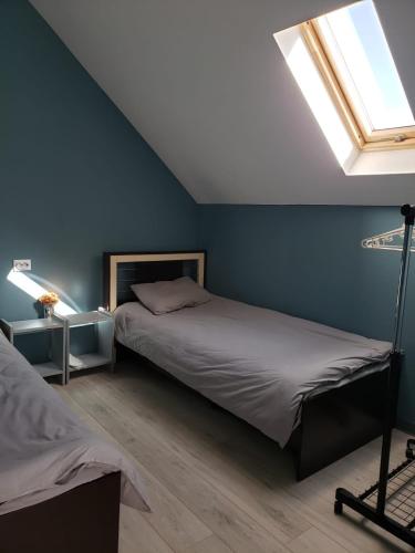 a bedroom with two beds and a window at Apartment Natura in Tbilisi City