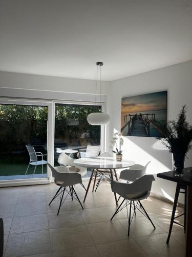 a dining room with a white table and chairs at Dream in Sibenik in Šibenik