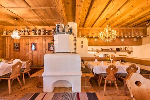a large dining room with tables and a refrigerator at Hotel Waldgasthof Buchenhain in Baierbrunn