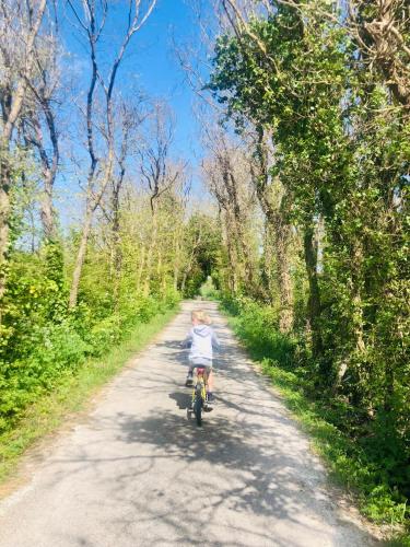 a child riding a bike down a dirt road at Annonce supprimée in Dolus d'Oléron