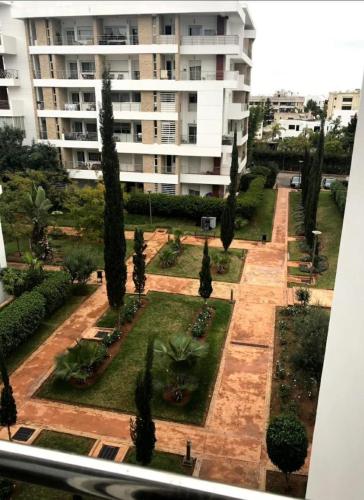 a view of a courtyard with trees and a building at Prestigia luxurious and cosy apartment 169 m2 in Rabat