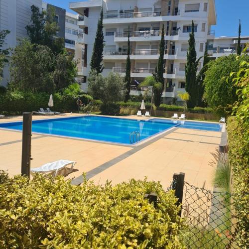 a swimming pool in front of a building at Prestigia luxurious and cosy apartment 169 m2 in Rabat