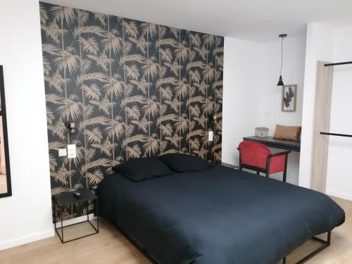 une chambre avec un lit noir et un papier peint noir et blanc dans l'établissement LOFT DE SOPHIE & YOHAN plain pied, à Saint-Martin-Boulogne