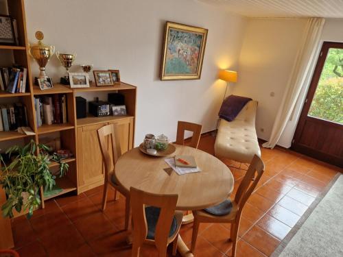 a living room with a table and a chair at Eifel Ferienhaus Luna in Ohlenhard